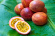 Ripe passion fruit, on a wet banana leaf. Vitamins, fruits, healthy foods