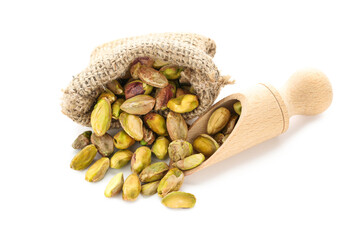 Poster - Tasty pistachios in sack and scoop on white background