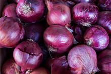 Close-up Pile of red onions in husk, may be used for background