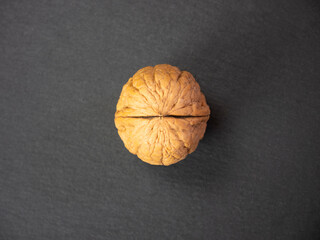 Wall Mural - Walnut on slate plate top view, central image of walnut