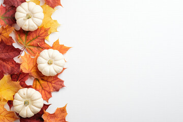Wall Mural - Autumn frame made of orange maple leaves and pumpkins on white background. Autumn fall, harvest, thanksgiving concept. Flat lay style composition, top view, copy space.
