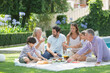 © Tom Merton/Caia Image - Multi-generation family enjoying picnic in sunny garden