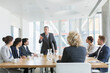 © Martin Barraud/Caia Image - Corporate businessman leading conference room meeting