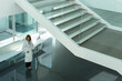 © Martin Barraud/Caia Image - Female doctor in modern hospital lobby