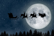 Super Santa Claus Man, A Super Hero Flying Over The Full Moon Leading His Reindeer At Night Christmas.