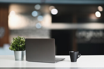 Wall Mural - Modern workspace with computer laptop and decorations on white table.