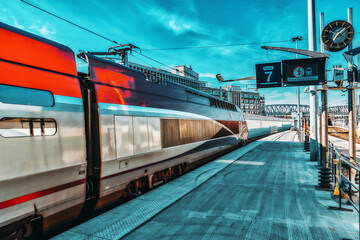 Modern speed passenger train on railways station.