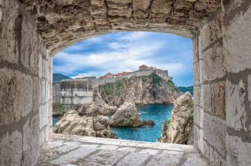 Wall Mural - View from stone window of cliffs, sea and Dubrovnik historic wall