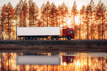 Red truck on a road at sunset