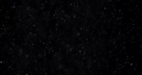 Dust particles in the air, black background