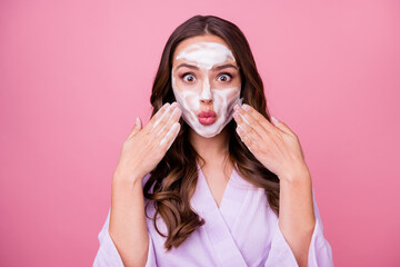 Wall Mural - photo portrait of young woman with pouted lips applying hydrating foam on skin looking natural fresh