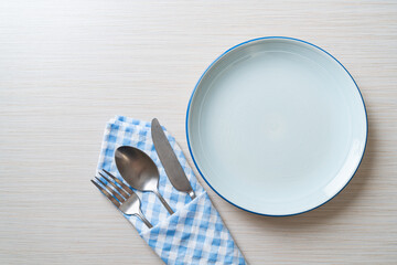 Wall Mural - empty plate or dish with knife, fork and spoon