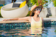 © siraphol - Portrait beautiful young asian woman relax smile leisure around outdoor swimming pool