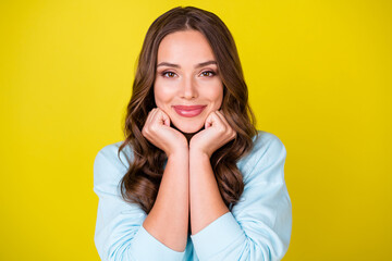 Wall Mural - Photo of lovely pretty charming young lady hands hold face smiling dream meet handsome guy imagine wedding ceremony wear blue sweater isolated vibrant yellow color background