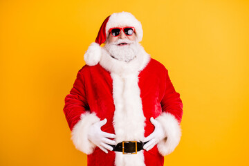 Wall Mural - Portrait of his he nice funny glad cheerful cheery white-haired Santa big belly stomach abdomen laughing ho-ho having fun isolated bright vivid shine vibrant yellow color background