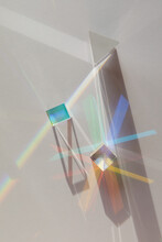 Glass Geometric Figures Prisms With Light Diffraction Of Spectrum Colors And Complex Reflection With Trendy Light And Hard Shadows On A White Background