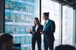 © BullRun - Business partners in modern office watching presentation on tablet