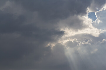 Wall Mural - ray lights through white cloud on sky. natural sun beams.