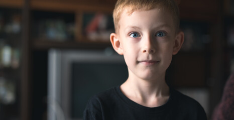 Little boy with cute face amazedly gazing at camera