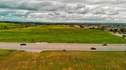 Canvas Print - Road in the countryside, aerial view from drone on a cloudy day