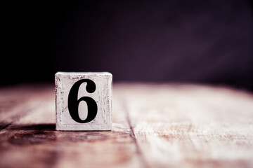 number 6 isolated on dark background- 3d number six isolated on vintage wooden table