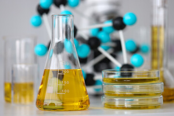 glass test tubes with yellow viscous liquid stand on table in chemical laboratory closeup. checking 