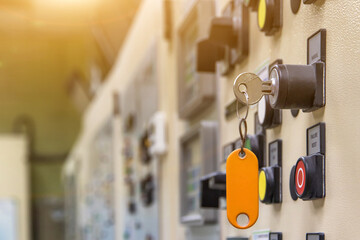 Key switch select mode in electrical control panel contains switch buttons for operating industrial machine and factory equipment in industry