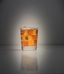 Wall Mural - Glass of iced tea backlit on dark grey background