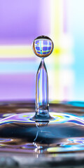 Perfect water droplet on light blue and violet background - water issues, water shortage, resources