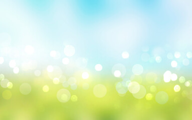 Wall Mural - Green grass blue sky blurred bokeh background.Nature landscape defocused backdrop.