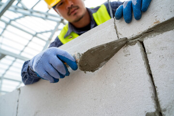 Aufkleber - Construction worker plastering cement at wall for building house.
