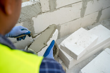 Aufkleber - Construction worker plastering cement at wall for building house.