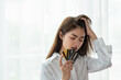© surachetkhamsuk - Young Asian business woman holding credit card with feeling unhappy, Financial problem concept