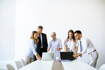 Senior businesswoman working together with young business people in office