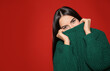 © New Africa - Pretty woman wearing warm sweater on red background. Space for text