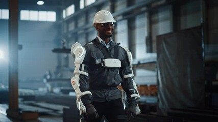Fototapete - Black African American Engineer is Testing a Futuristic Bionic Exoskeleton and Proudly Wearing it in a Heavy Steel Industry Factory. Successful Contractor Walking in a Powered Mobile Machine Shell.