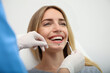 © New Africa - Doctor examining patient's teeth on light background, closeup. Cosmetic dentistry