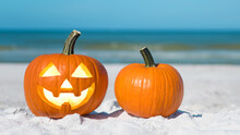 Pumpkin Jack-o'-lantern On The Beach.  Jack-o-lantern For Happy Halloween. Autumn Season. On Background Turquoise Ocean Water. Autumn In Florida. Fall Season. Tropical Nature.