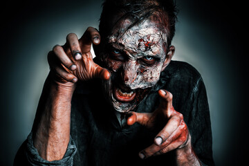 Scary zombie on dark background. Halloween monster