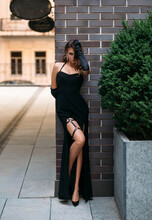 A Beautiful Young Retro Woman In A Black Evening Dress