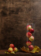 homemade juicy red apples in a transparent vase autumn fruits and vegetables on a brown wooden background fresh vitamins healthy food concept
