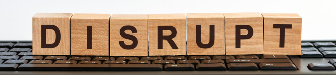 disrupt word made with building blocks jn the black keyboard.