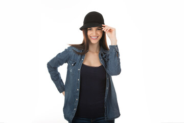 Cute teenage girl touching her black hat in sign of salute