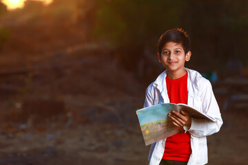 Indian Asian school boy with note book and studying at home