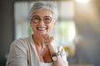 © goodluz - portrait of a beautiful smiling 55 year old woman with white hair