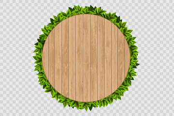 Wall Mural - Wooden round background with green leaves behind.