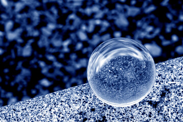 Wall Mural - A lens ball with reflections. A glass ball in blue.