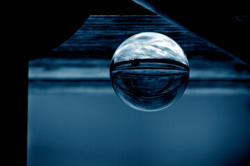Wall Mural - A lens ball with reflections. A glass ball in blue.
