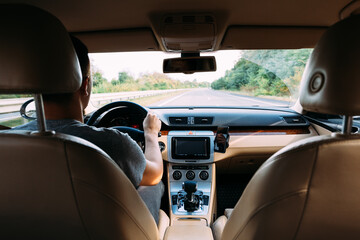 Wall Mural - The young man driving the modern car on asphalt road