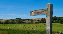 A Wooden Sign Stating Public Footpath In The Countryside